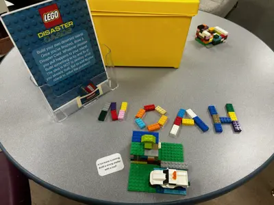 LEGO pieces spell out the name "NOAH" from a STEM activity offered at the library.